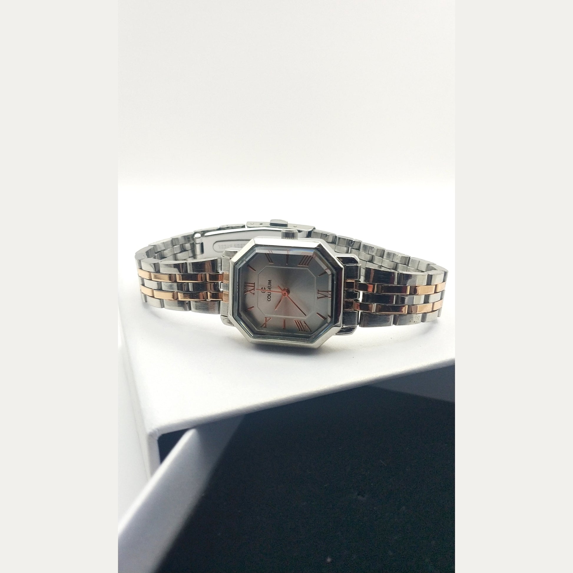 Women’s silver stainless steel watch with octagon dial and rose gold Roman numerals – elegant modern accessory