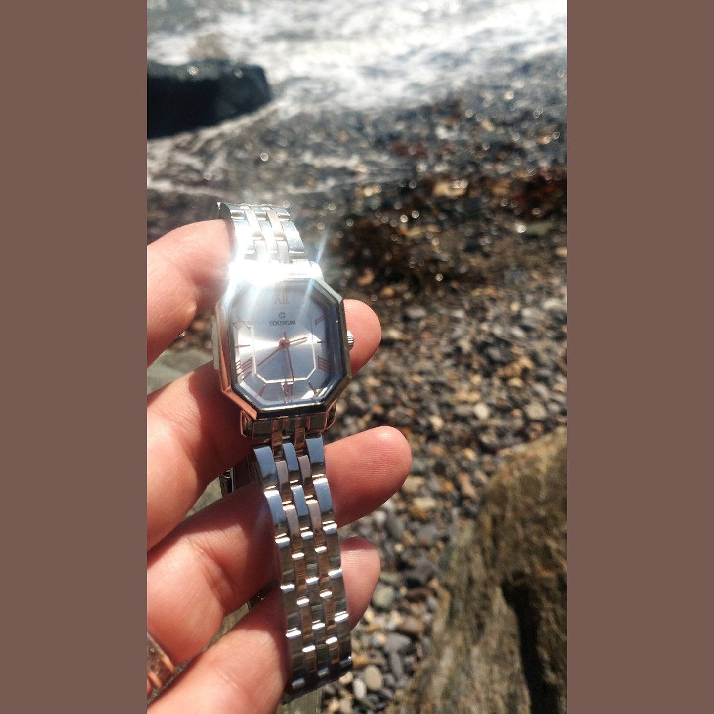 Women’s silver stainless steel watch with octagon dial and rose gold Roman numerals – elegant modern accessory