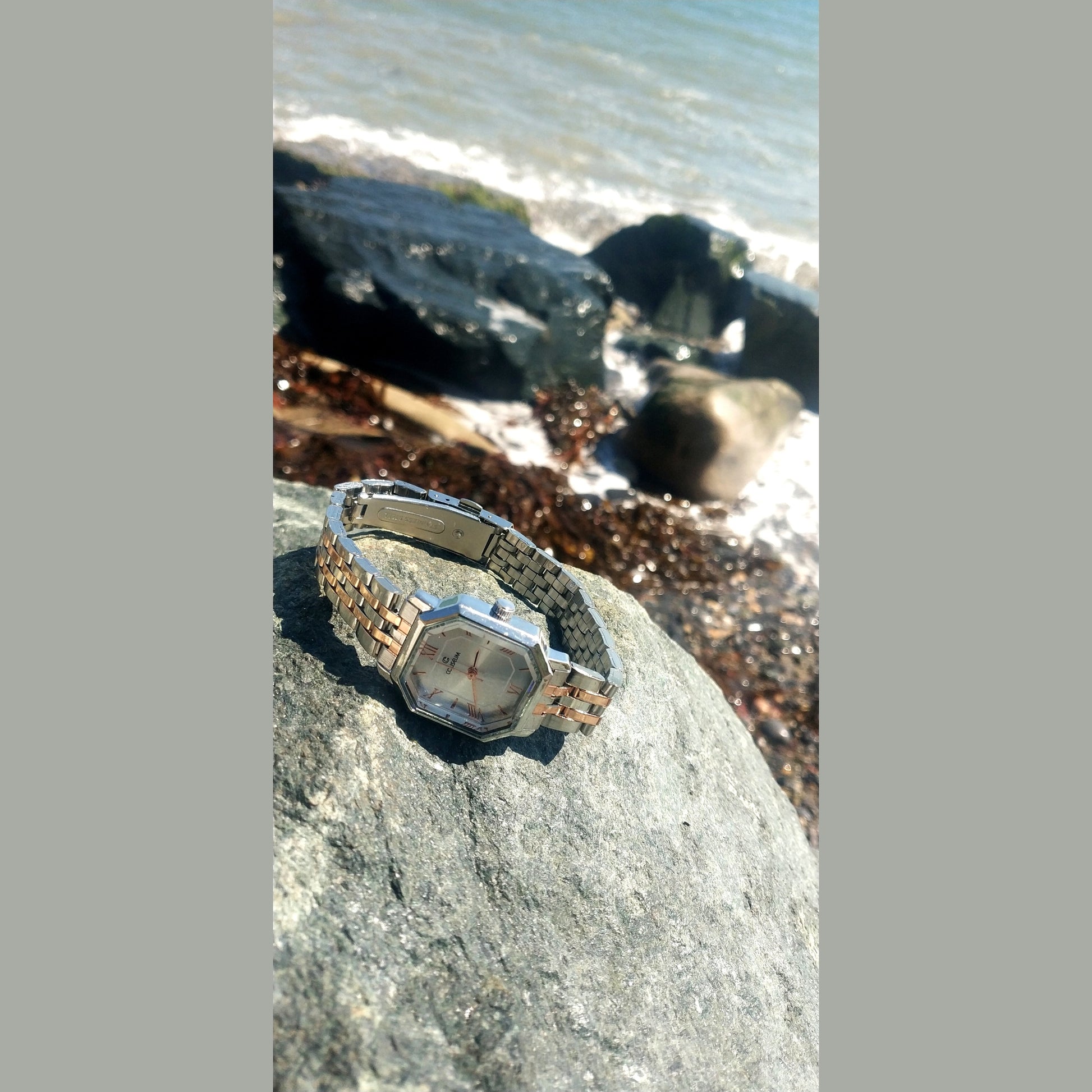 Women’s silver stainless steel watch with octagon dial and rose gold Roman numerals – elegant modern accessory