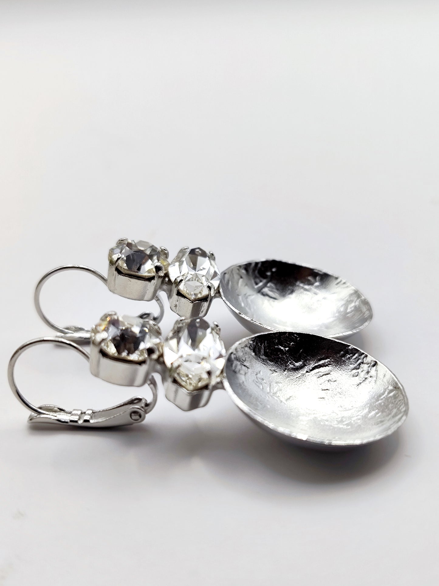 Santorini earrings with crystal – Greek hammered jewelry in 18K gold plated, 18K silver plated, and rose gold plated. Handcrafted earrings with hammered discs and sparkling crystals inspired by the island of Santorini.