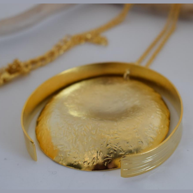 Eos Necklace – Greek Hammered Jewelry – 18K Gold, Silver, or Rose Gold Plated. Handmade circular hammered pendant with sculptural curves inspired by the goddess of dawn.