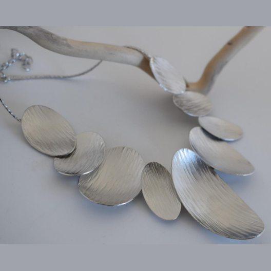 Nausicaa Necklace – Greek Hammered Jewelry – 18K Gold, Silver, or Rose Gold Plated. Statement necklace with hammered overlapping ovals inspired by sea waves.