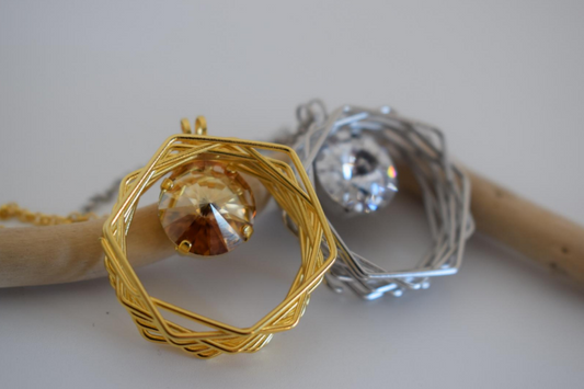 Folia Necklace With Crystal – Greek Hammered Jewelry – Available in 18K Gold or Silver Plated. Circular nest-inspired design encasing Swarovski crystal.