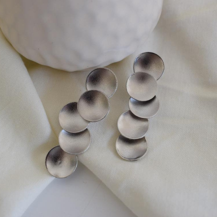 Mycenae earrings in Greek hammered circular design, available in 18K gold plated and 18K silver plated finishes.
