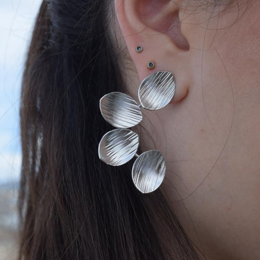 Anemone handmade Greek hammered earrings with petal-inspired elements, available in gold and silver plated finishes.
