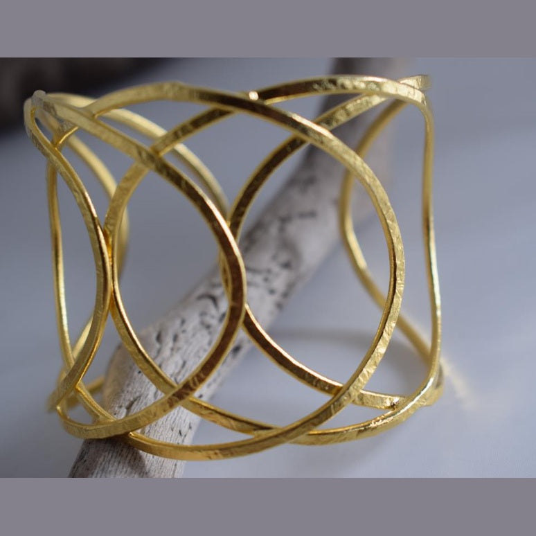 Thetis bracelet – Greek hammered jewelry with openwork wave-inspired design, available in 18K gold-plated, 18K silver-plated, and rose-gold plated finishes.