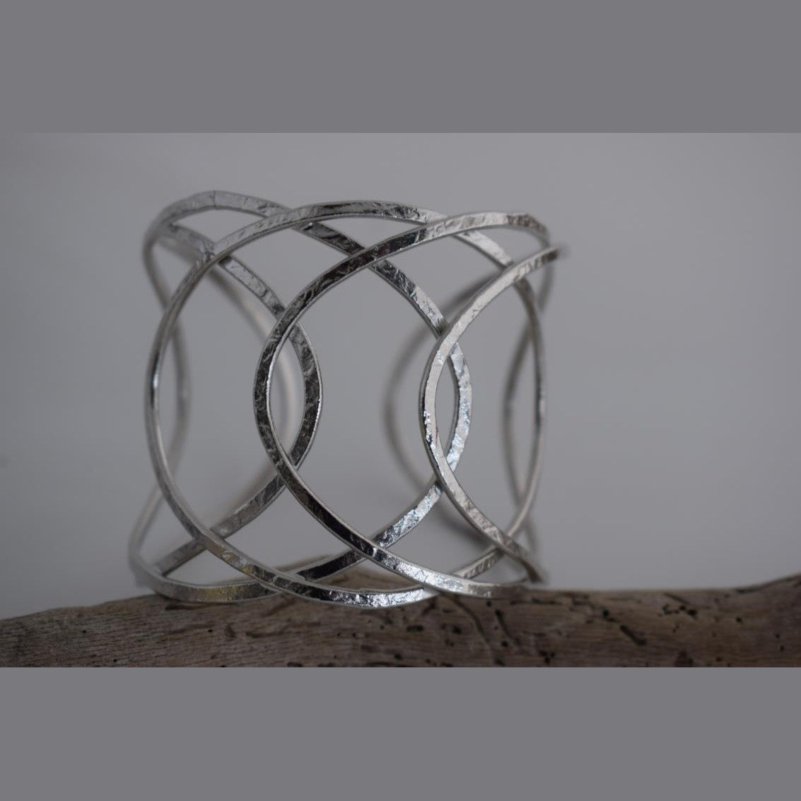 Thetis bracelet – Greek hammered jewelry with openwork wave-inspired design, available in 18K gold-plated, 18K silver-plated, and rose-gold plated finishes.