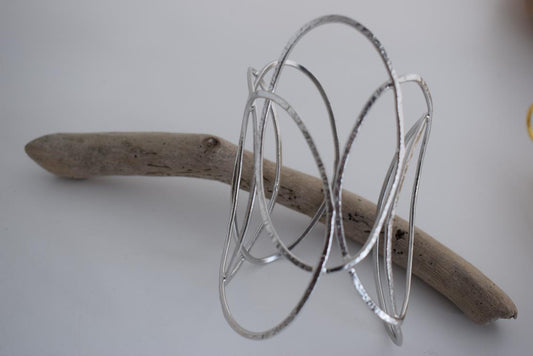 Elysia bracelet – Greek hammered jewelry with openwork interlaced design, available in 18K gold-plated, 18K silver-plated, and rose-gold plated finishes.