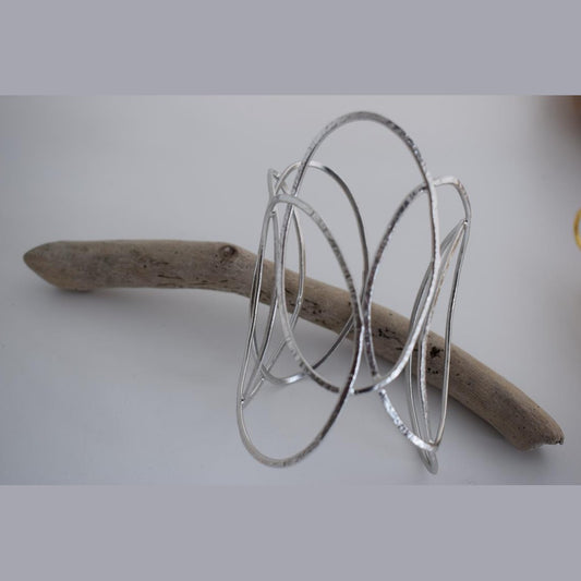 Elysia bracelet – Greek hammered jewelry with openwork interlaced design, available in 18K gold-plated, 18K silver-plated, and rose-gold plated finishes.