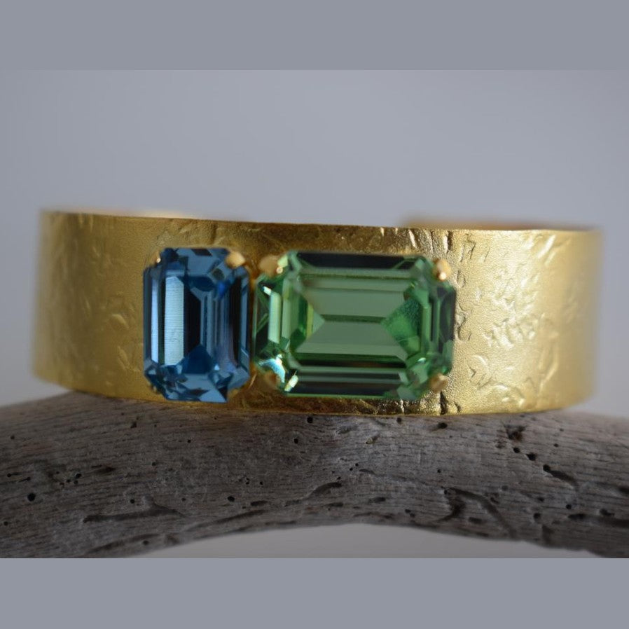 Electra bracelet – Greek hammered jewelry cuff with emerald-cut crystals, inspired by the radiant heroine Electra, available in 18K gold-plated, 18K silver-plated, and rose-gold plated finishes.