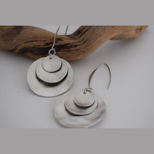 Selini earrings – Greek hammered jewelry with layered discs inspired by moon phases, available in 18K gold-plated, 18K silver-plated, and rose-gold plated finishes.