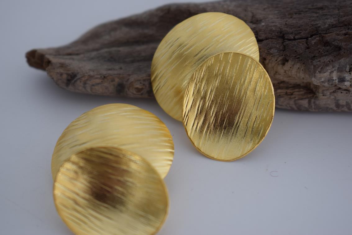 Ostraka earrings – Greek hammered jewelry with bold round textured discs, inspired by ancient Greek pottery shards, available in 18K gold-plated, 18K silver-plated, and rose-gold plated finishes.