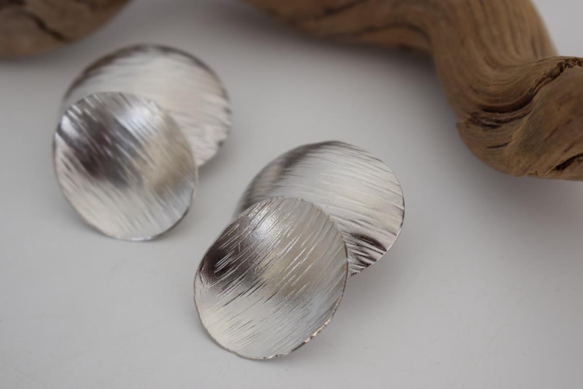 Ostraka earrings – Greek hammered jewelry with bold round textured discs, inspired by ancient Greek pottery shards, available in 18K gold-plated, 18K silver-plated, and rose-gold plated finishes.