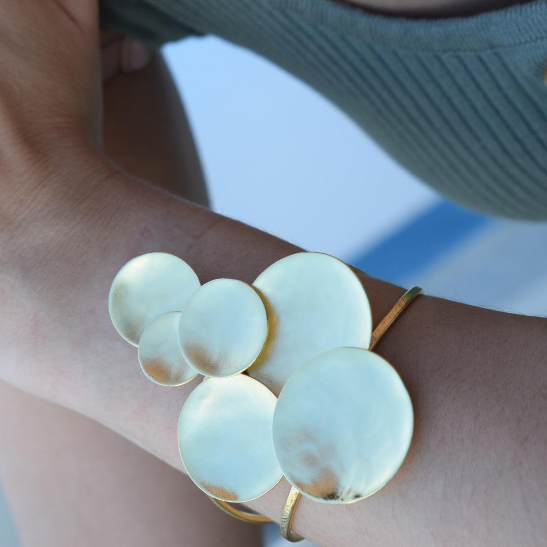 Ampelos bracelet – Greek hammered jewelry with grape motif, available in 18K gold-plated, 18K silver-plated, and rose-gold plated finishes.