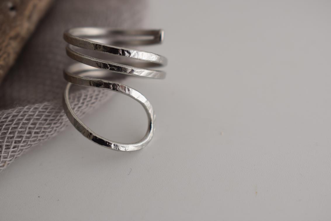 Ocean ring Greek hammered jewelry with spiral wave-inspired design, available in gold, silver, and rose gold plated.