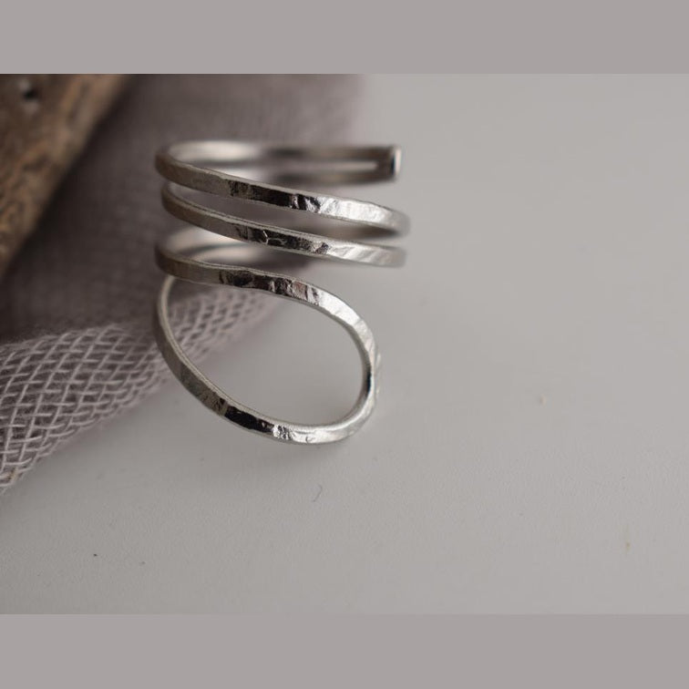 Ocean ring Greek hammered jewelry with spiral wave-inspired design, available in gold, silver, and rose gold plated.