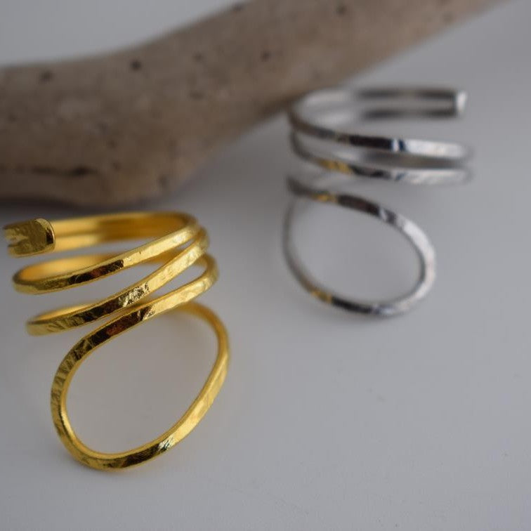 Ocean ring Greek hammered jewelry with spiral wave-inspired design, available in gold, silver, and rose gold plated.
