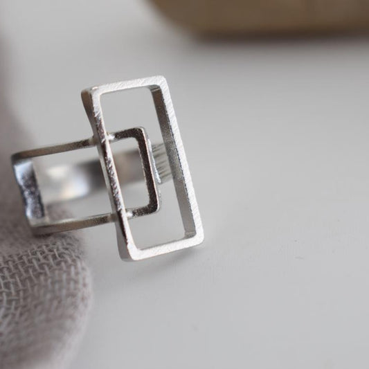 Geometria ring Greek hammered jewelry with rectangular openwork design, available in gold, silver, and rose gold plated.