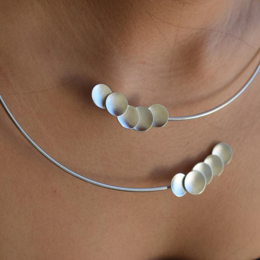 Mycenae necklace in Greek hammered disc design, worn as a minimalist choker and available in 18K gold plated and 18K silver plated finishes.