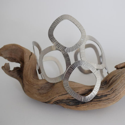 Kyklades Bracelet – handmade Greek hammered jewelry with openwork geometric design, available in 18K gold and silver plated.