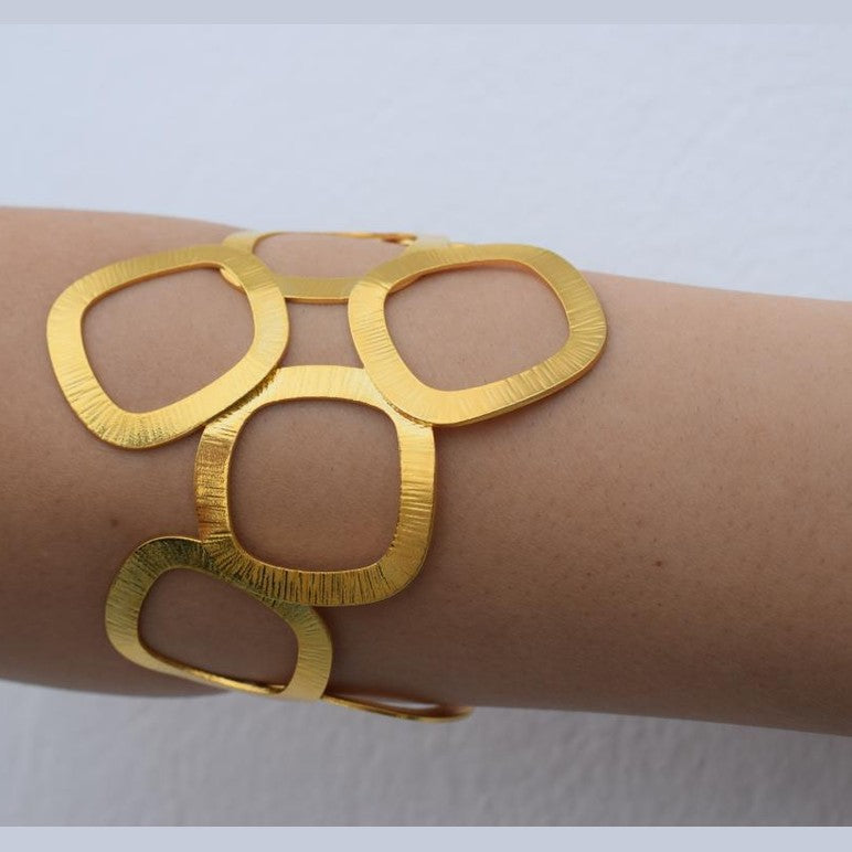 Kyklades Bracelet – handmade Greek hammered jewelry with openwork geometric design, available in 18K gold and silver plated.