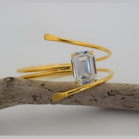 andmade Axon bracelet, Greek hammered jewelry in 18K gold or silver plated featuring a single Swarovski crystal on a sculptural open cuff.