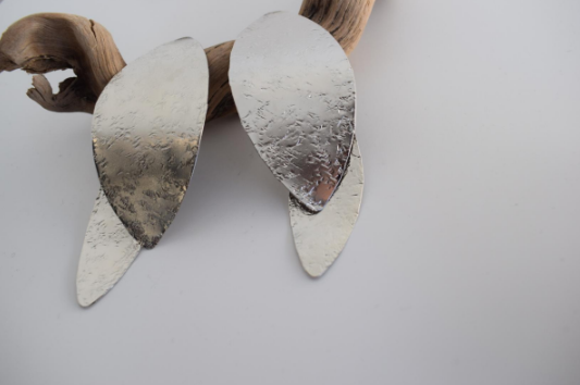 Nymphe Earrings – Greek Hammered Jewelry – Available in 18K Gold, Silver, and Rose Gold Plated. Handmade elongated hammered leaf-inspired design, symbolizing the grace of ancient nymphs.