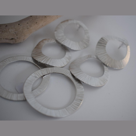 Kyklades Earrings – Greek Hammered Jewelry – Available in 18K Gold, Silver, and Rose Gold Plated. Handmade cascading hammered circles inspired by the Cycladic islands and Aegean heritage.