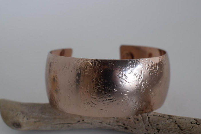 Handmade wide cuff bracelet with hammered texture inspired by the Aegis shield of Zeus and Athena, available in gold, silver, or rose gold plating.