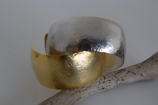 Handmade wide cuff bracelet with hammered texture inspired by the Aegis shield of Zeus and Athena, available in gold, silver, or rose gold plating.