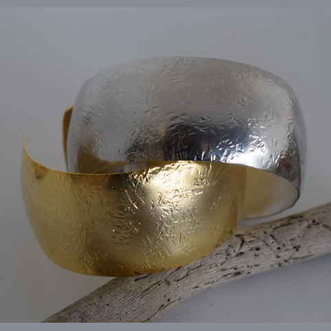 Handmade wide cuff bracelet with hammered texture inspired by the Aegis shield of Zeus and Athena, available in gold, silver, or rose gold plating.