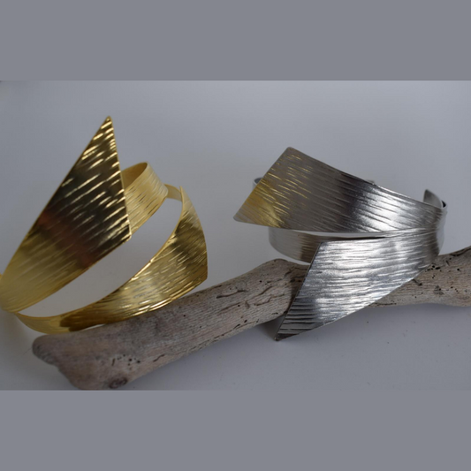 Handmade sculptural wrap bracelet with textured finish inspired by the draped folds of the ancient Greek chiton garment, available in gold, silver, or rose gold plating.