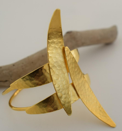 Handmade open cuff bracelet with elongated hammered spear-like elements inspired by Nike, the ancient Greek goddess of victory, available in gold, silver, or rose gold plating.