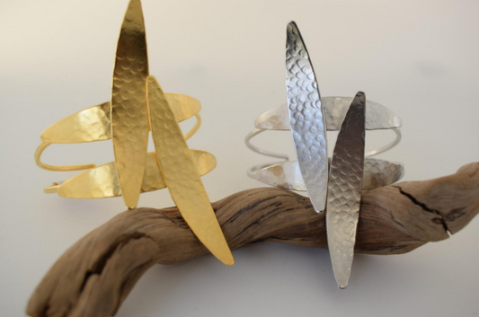 Handmade open cuff bracelet with elongated hammered spear-like elements inspired by Nike, the ancient Greek goddess of victory, available in gold, silver, or rose gold plating.