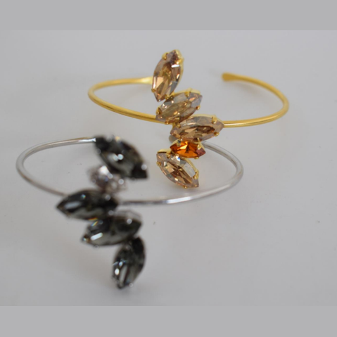 Handmade open cuff bracelet with marquise-cut Swarovski crystals arranged in a leaf pattern, inspired by the Amaryllis flower in ancient Greek culture, available in gold, silver, or rose gold plating.