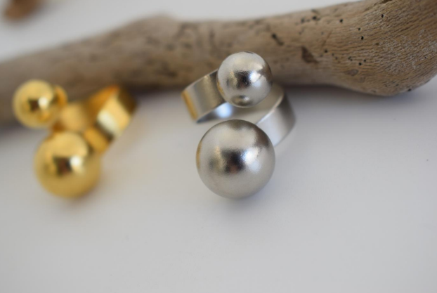 Sphaira Ring – Greek Hammered Jewelry – Available in 18K Gold, Silver, and Rose Gold Plated. Adjustable open ring with twin spheres, inspired by the ancient Greek symbol of the cosmos.