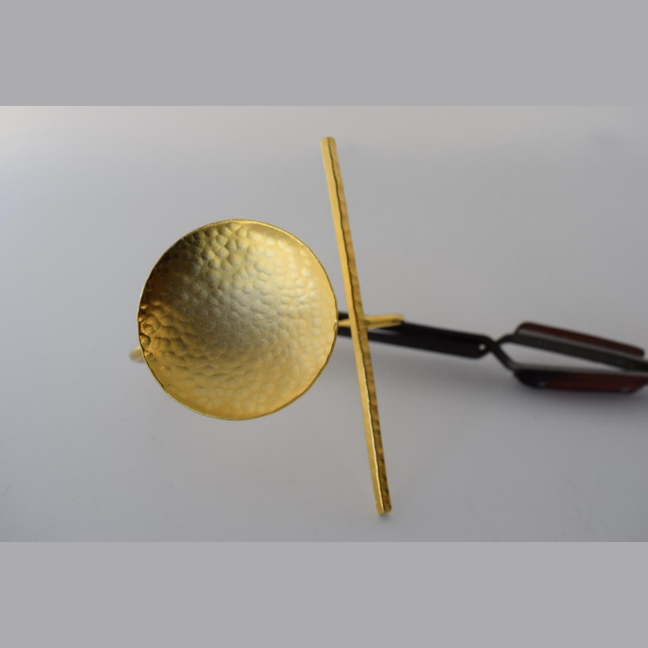 Handmade open cuff bracelet with hammered disc and vertical bar inspired by the ancient Greek concept of the axis of balance, available in gold, silver, or rose gold plating.