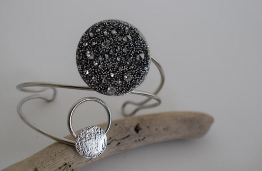 Handmade open cuff bracelet with Swarovski-studded disc inspired by the Milky Way, available in gold, silver, or rose gold plating.