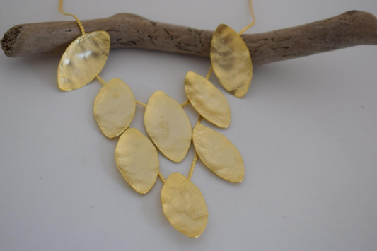 Handmade hammered necklace with gold-plated leaf shapes inspired by Greek nature and mythology.