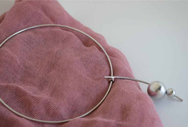 Handmade gold-plated choker necklace with two golden spheres inspired by the cosmos, Greek hammered jewelry design.