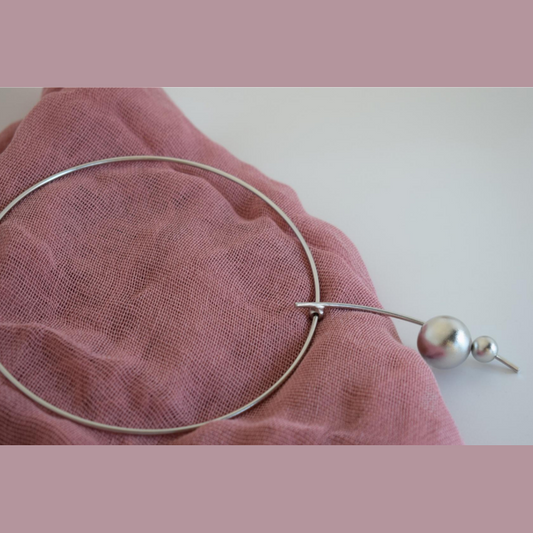 Handmade gold-plated choker necklace with two golden spheres inspired by the cosmos, Greek hammered jewelry design.