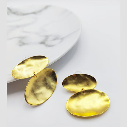 Heliades Earrings – Greek Hammered Jewelry – Available in 18K Gold, Silver, and Rose Gold Plated. Radiant hammered circular discs inspired by the daughters of the Sun.