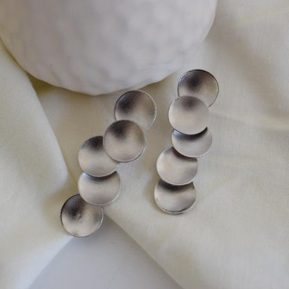 Mycenae earrings in Greek hammered circular design, available in 18K gold plated and 18K silver plated finishes.