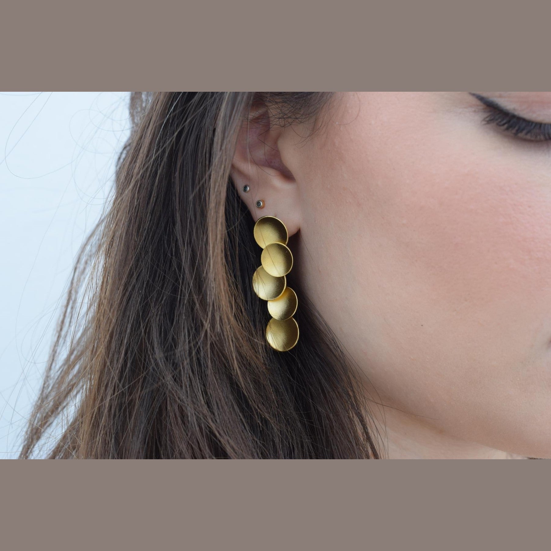 Mycenae earrings in Greek hammered circular design, available in 18K gold plated and 18K silver plated finishes.
