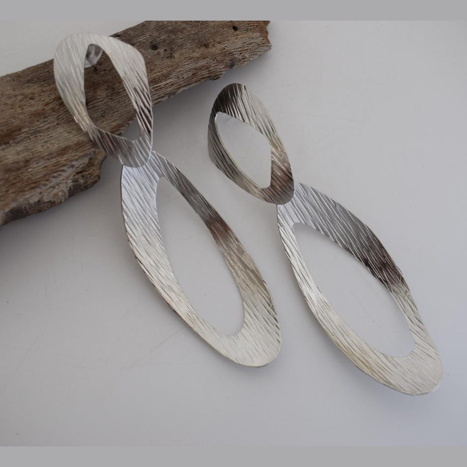 Ostraka earrings in Greek hammered open oval design, available in 18K gold plated and 18K silver plated finishes.