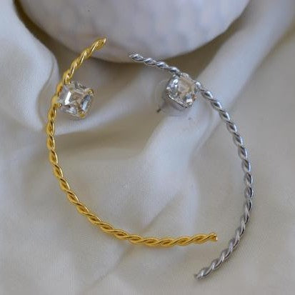 Okeanos earrings in Greek hammered twisted hoop design with fine crystals, available in 18K gold plated and 18K silver plated finishes.