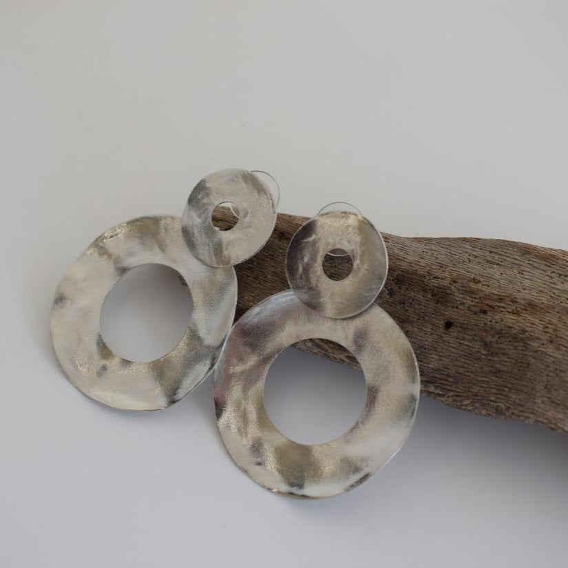 Labrys handmade Greek hammered earrings shown in gold plated finish and available in gold and silver plated options.