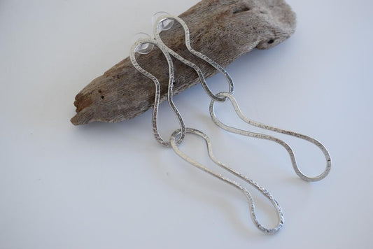 Aigle2 handmade Greek hammered earrings with an elongated sculptural design, available in gold and silver plated finishes.