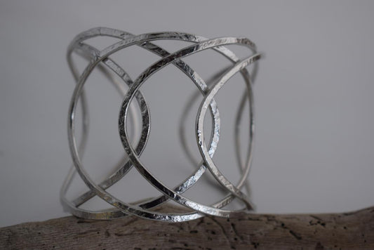 Thetis bracelet – Greek hammered jewelry with openwork wave-inspired design, available in 18K gold-plated, 18K silver-plated, and rose-gold plated finishes.