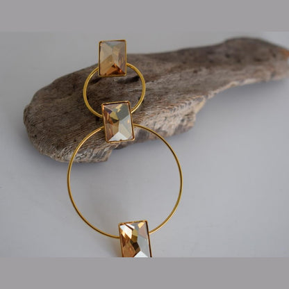 Ionio earrings with crystal – Greek hammered jewelry with hoops and faceted stones, inspired by the Ionian Sea, available in 18K gold-plated, 18K silver-plated, and rose-gold plated finishes.